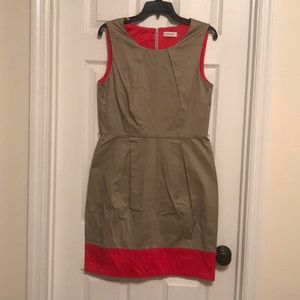 Tan cocktail dress with orange detail.